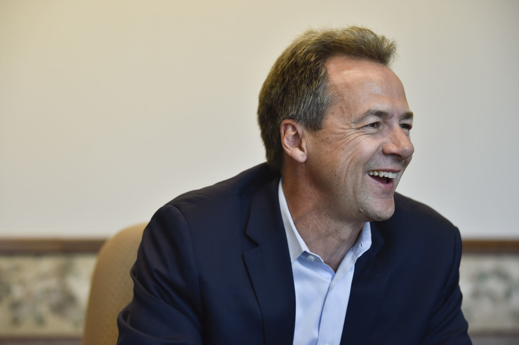 Gov. Steve Bullock talks with a reporter